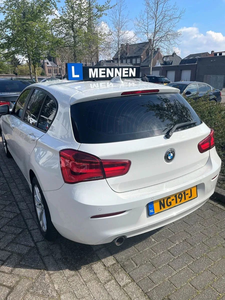 White BMW lesson car with the Mennen roof sign